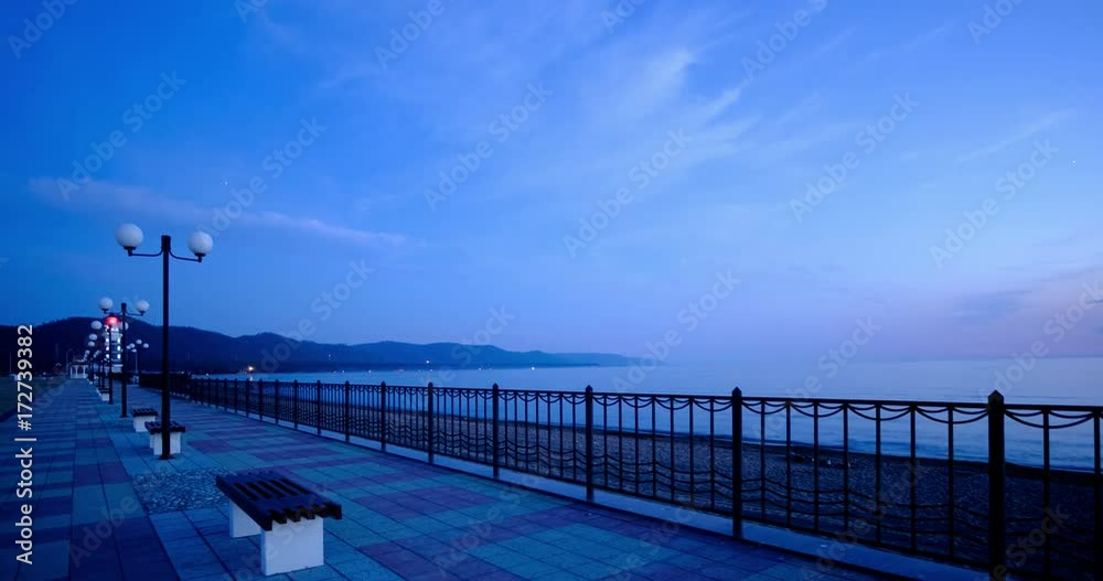 Beautiful in a deserted waterfront in the background can be seen mountains and a lighthouse Beautiful in a deserted waterfront in the background can be seen mountains and a lighthouse