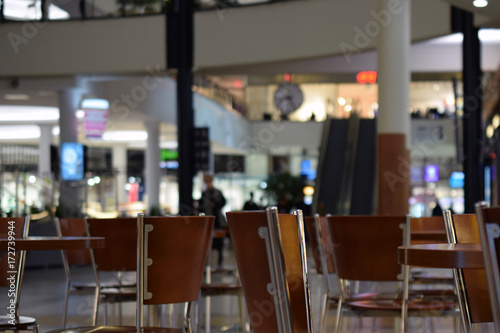 Empty shopping mall cafe. Focus on foreground  background blurred defocused.