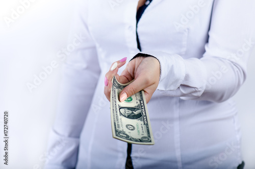 Businesswoman holding dollar banknotes isolated on a white background.Money in women's hands. American currency. One dollar banknotes