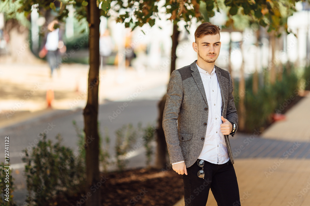 Young man walking on the street with blur background