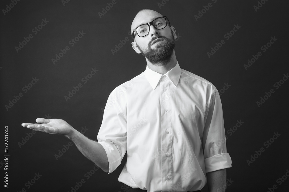 young white beard wearing glasses man white shirt black pants studio monochrome background hand out placeholder young white beard wearing glasses man white shirt black pants studio monochrome background hand out placeholder