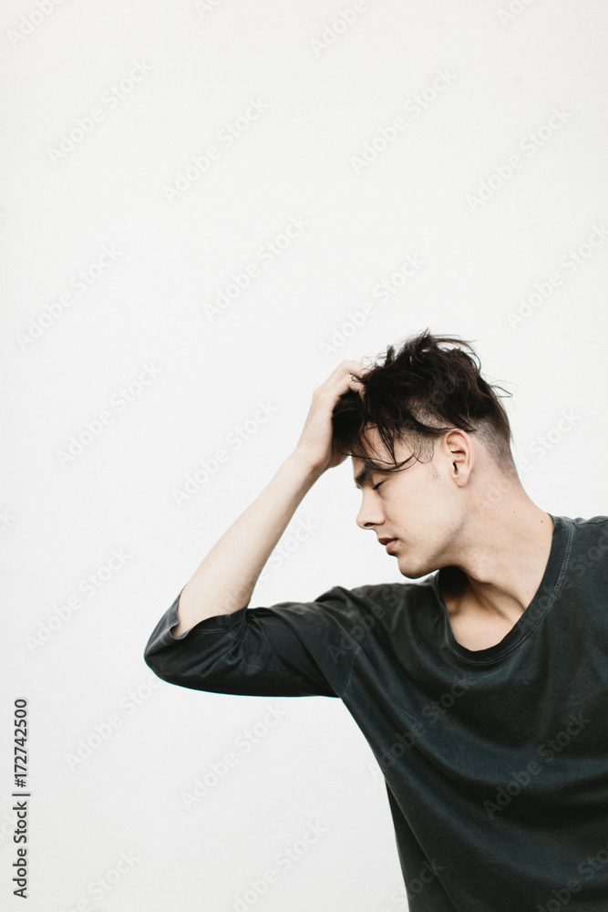 expressive portrait of man against white wall expressive portrait of man against white wall