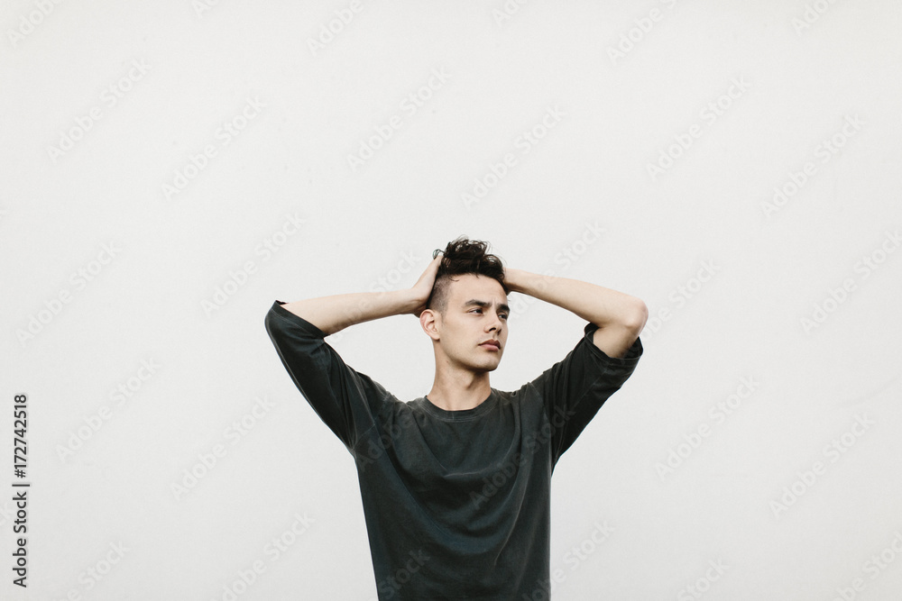 expressive portrait of man against white wall expressive portrait of man against white wall