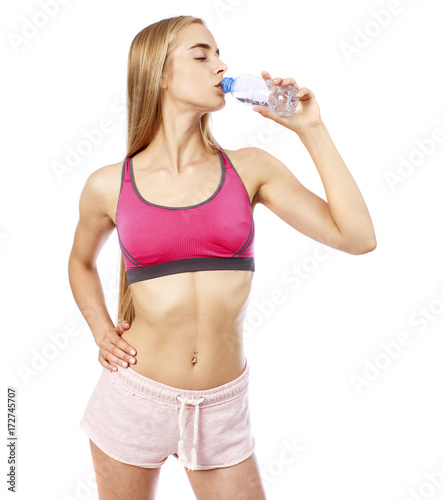 Young beautiful blonde girl drinking water from a bottle © Andrey_Arkusha