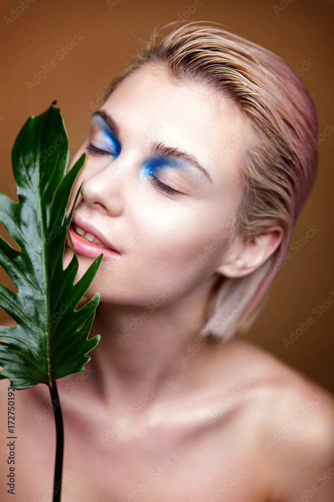 Beautiful fresh woman's face with leaf Beautiful fresh woman's face with leaf