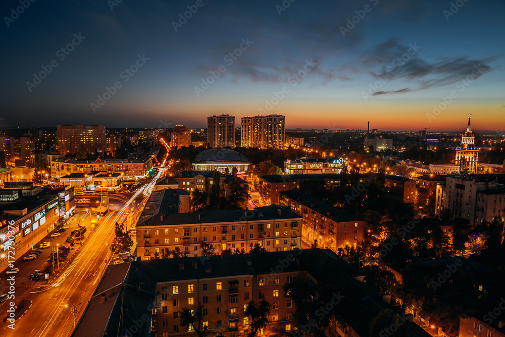 panorama of the night city center of Voronezh with streets, traffic, shopping centers or malls and apartment buildings, view from the height