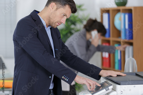 man pressing the amount of paper to be copied