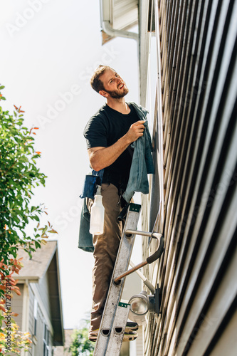 Wallpaper Mural Window Washer Holding Towel Spot Cleaning Outside of Window Whil Torontodigital.ca