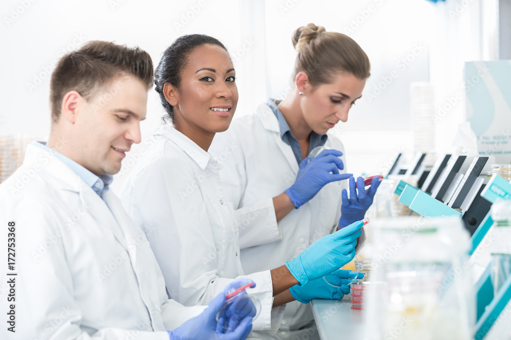 Group of researchers using scientific technology for test of germ samples Group of researchers using scientific technology for test of germ samples