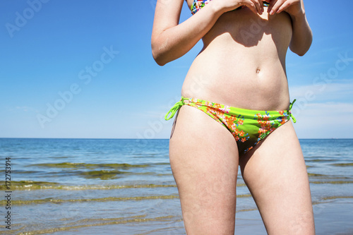 Girl in a swimsuit on the beach