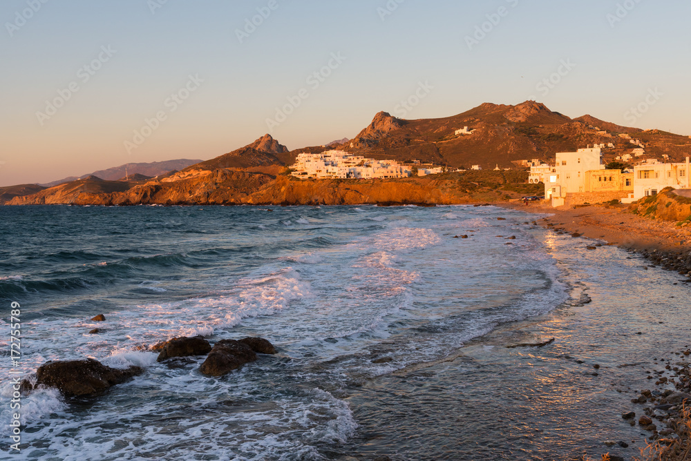 View of sea and houses on the hill in Chora town at sunset time. Naxos island. Cyclades, Greece. View of sea and houses on the hill in Chora town at sunset time. Naxos island. Cyclades, Greece.