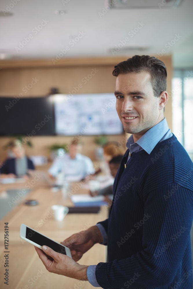 Portrait of smiling businessman using digital tablet - obrazy, fototapety, plakaty 