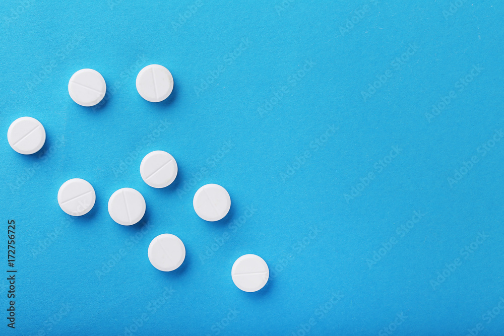 White pills on blue background White pills on blue background