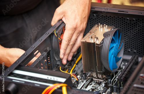 Obraz na płótnie Computer technician installs cooling system of computer. Assembling PC w salonie