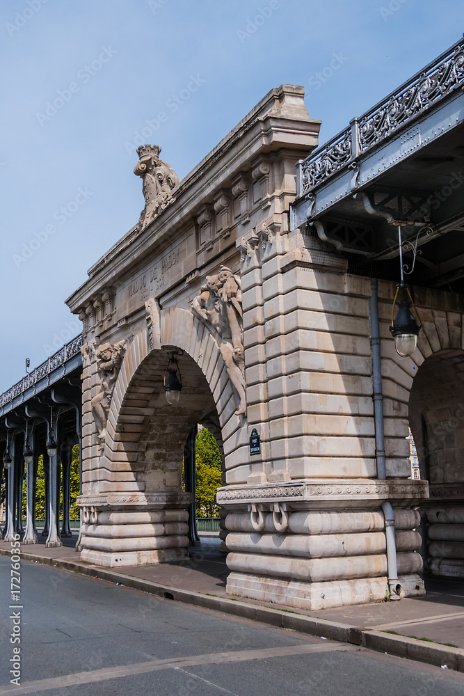 View of pont de Bir-Hakeim (formerly pont de Passy) - a bridge that crosses the Seine River in Paris. Bir-Hakeim bridge is 237 meters long. Central arch decorated with monumental statues. France.