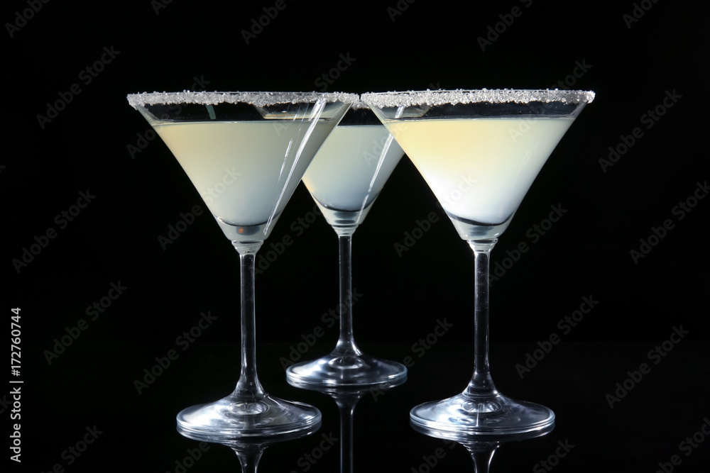Glasses of lemon drop martini on black background Glasses of lemon drop martini on black background