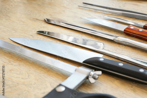 Set of knives on wooden background