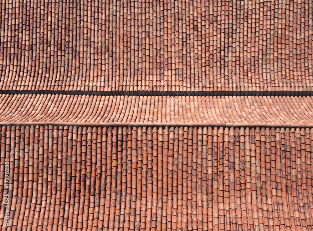 large tiled roof from above with rows and ridges in orange terracotta colors background large tiled roof from above with rows and ridges in orange terracotta colors background