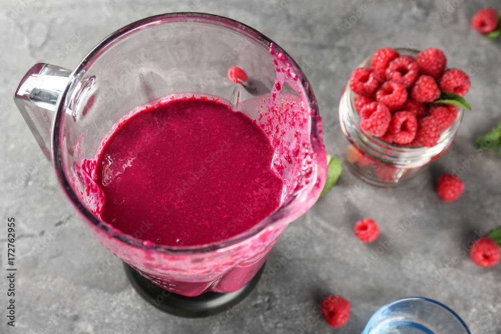 Blender with fresh smoothie on table Blender with fresh smoothie on table
