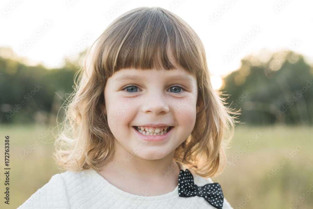 Young Girl smiles At The Camera