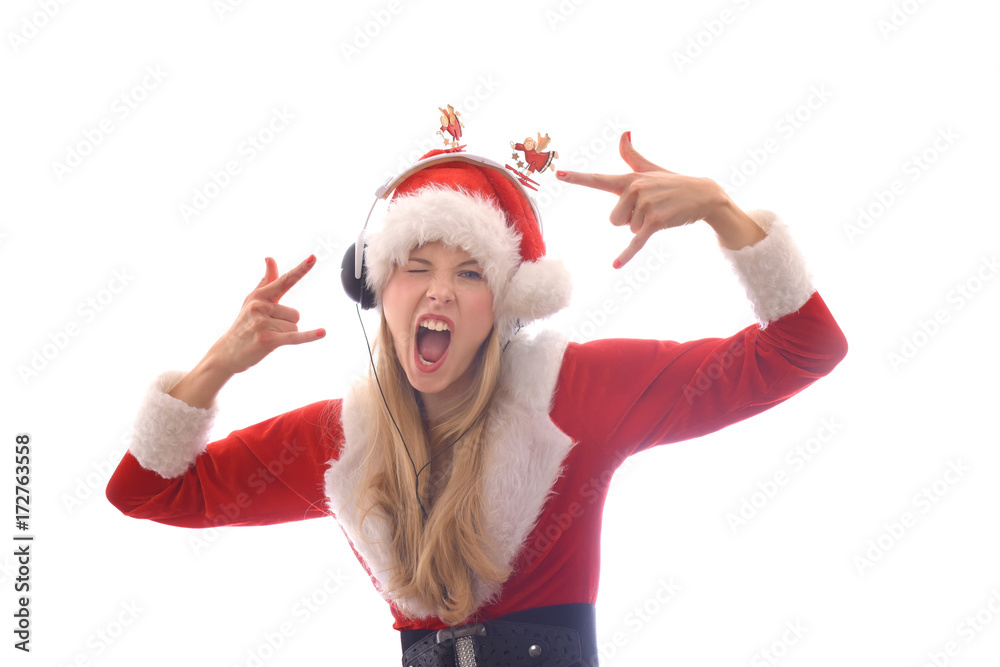 Obraz premium A young girl dresses up as Santa Claus and wants to hear Christmas music. She wears headphones on her head and shouts and yells out the songs she hears.