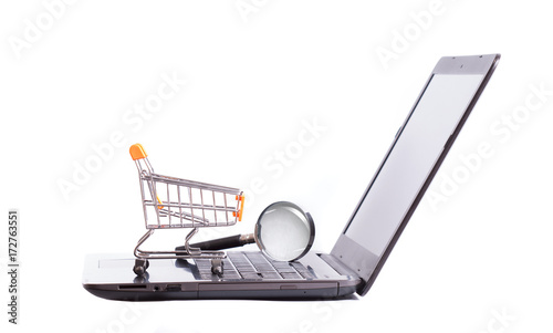 trolley on laptop and magnifying glass photo