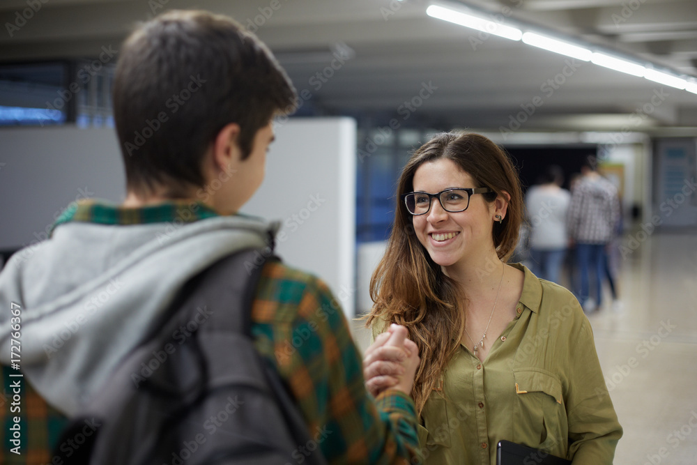 A student being congratulated by a friend A student being congratulated by a friend
