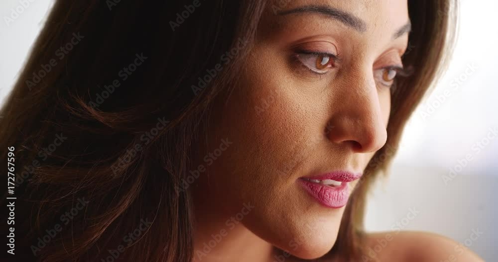 Close up of beautiful Latina female looking off camera with sad expression. Side view of attractive Mexican woman with worried look. 4k Close up of beautiful Latina female looking off camera with sad expression. Side view of attractive Mexican woman with worried look. 4k