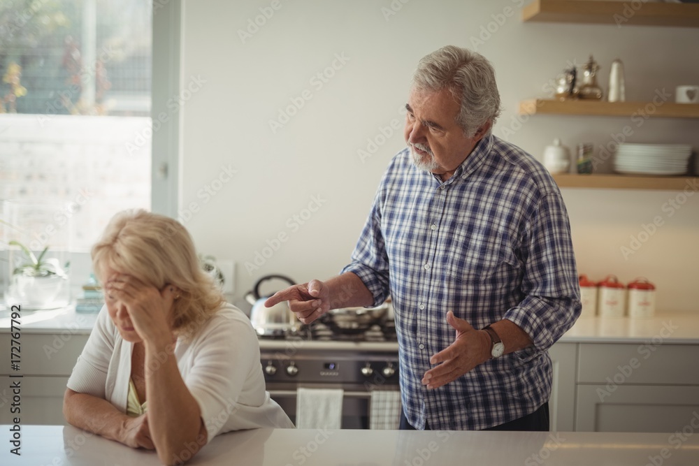 Senior couple arguing in kitchen Senior couple arguing in kitchen