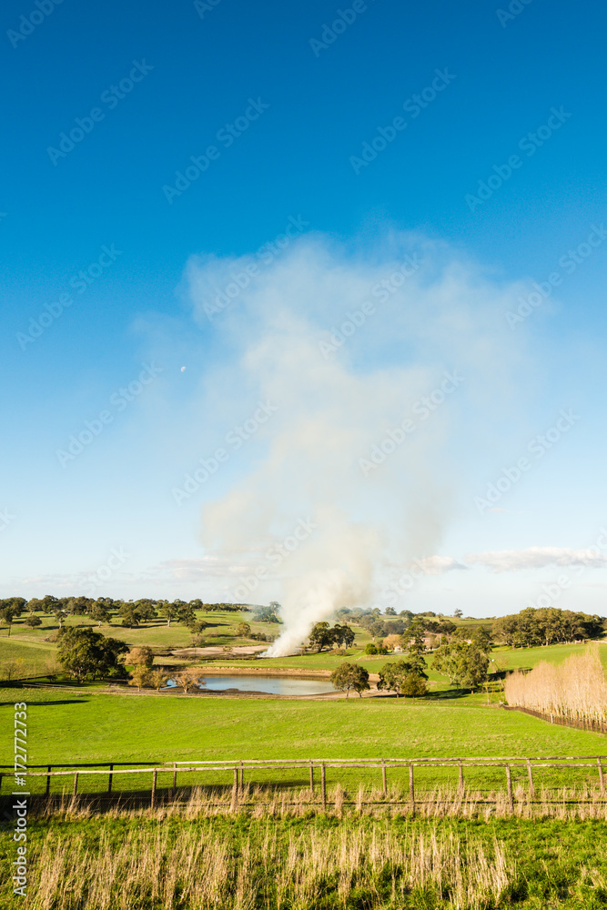 Smoke drifting in the air due to fire in the farm Smoke drifting in the air due to fire in the farm