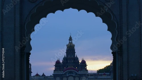 View of Mysore palace through the entrance arch, during dusk photo
