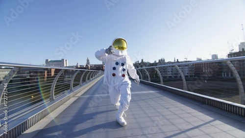  Funny astronaut exploring London, doing a dance on the Millennium footbridge.
