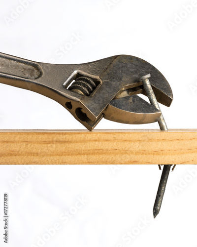 Adjustable wrench removing a nail