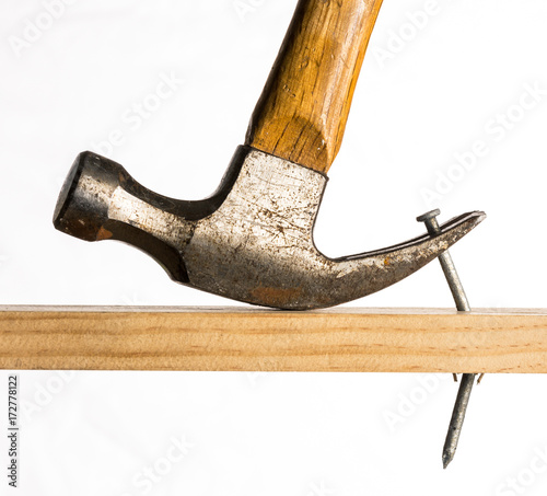 A claw hammer removing a nail photo