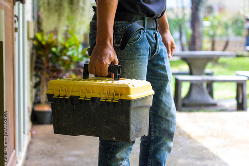 technician holding a toolbox photo
