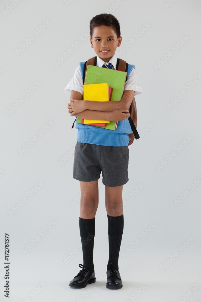 Schoolboy in school uniform with school bag on white background Schoolboy in school uniform with school bag on white background