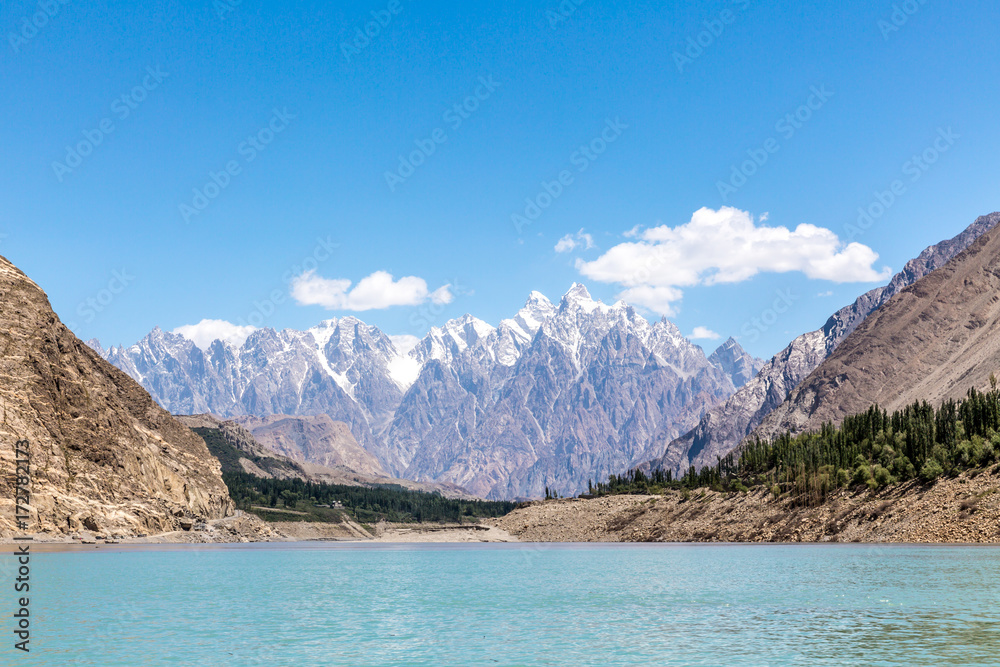A stunning view of the Karakoram mountain ranges from the boat across the Attabad lake that shines in emerald color