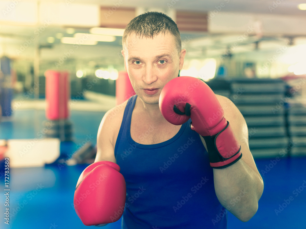 Portrait of active male who is boxing