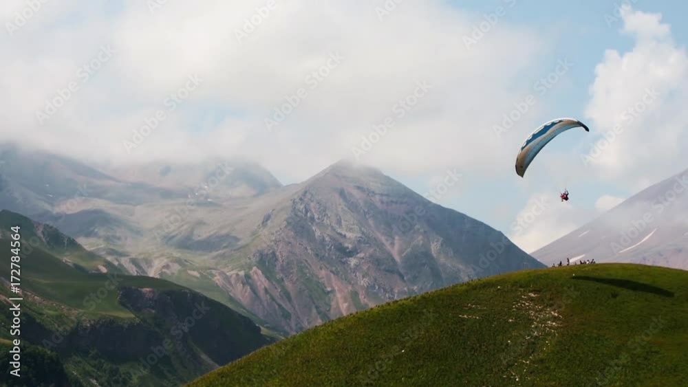4K Paragliders fly over amazing mountain range 4K Paragliders fly over amazing mountain range