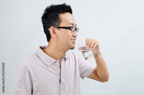 Asian male drinking mineral water