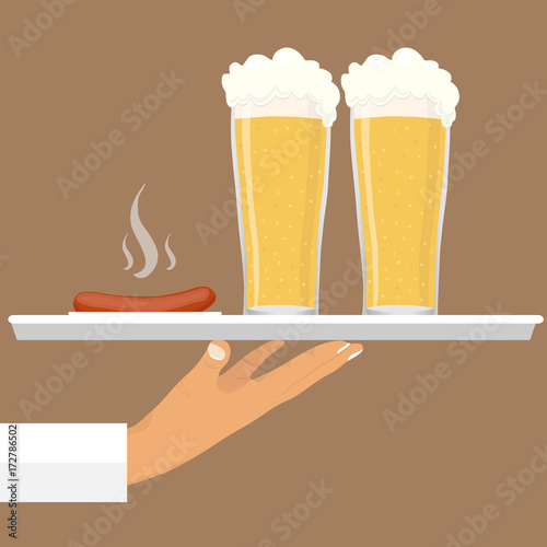 A glass of beer with a sausage on a tray