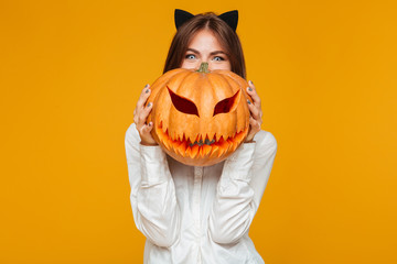 Happy young woman dressed in crazy cat halloween costume