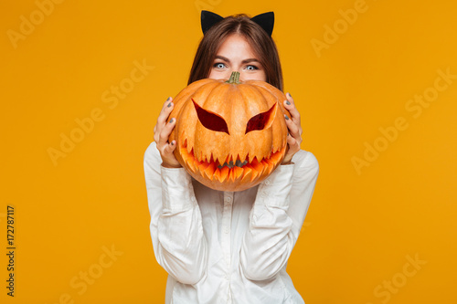 Happy young woman dressed in crazy cat halloween costume