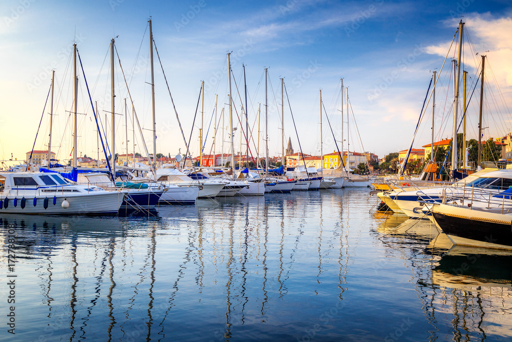 Harbor with docked boats in Porec town on Adriatic sea in Croatia, Europe.