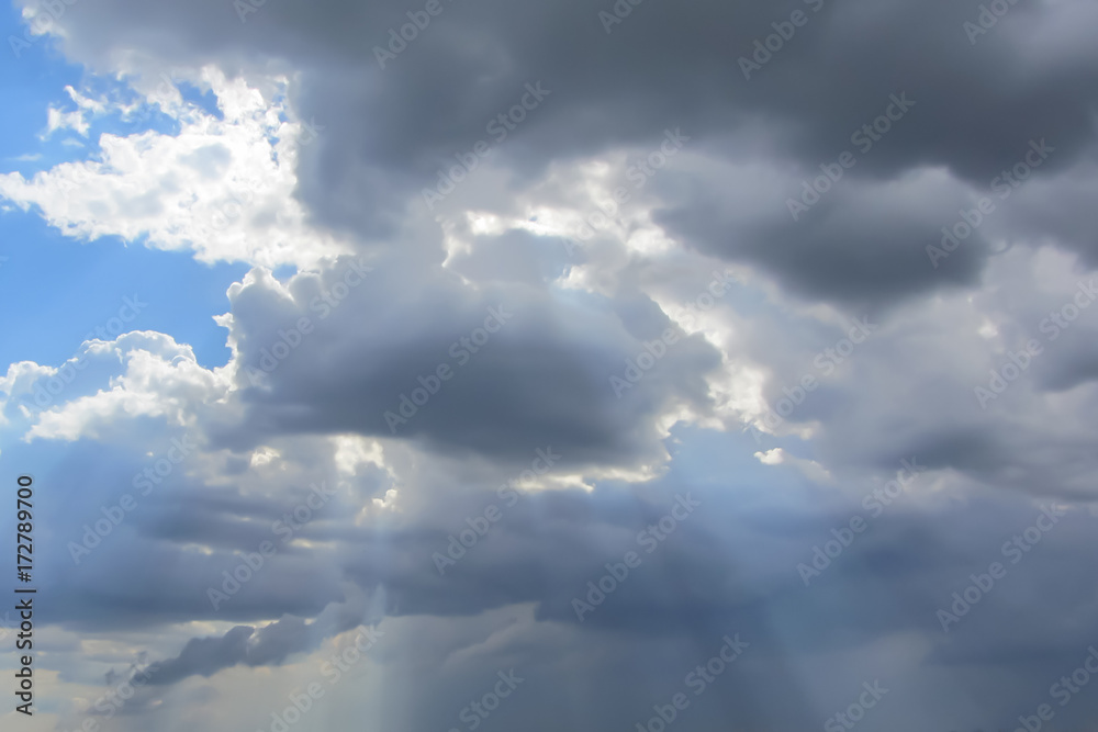 Sunshine from the dark clouds in the blue sky Sunshine from the dark clouds in the blue sky
