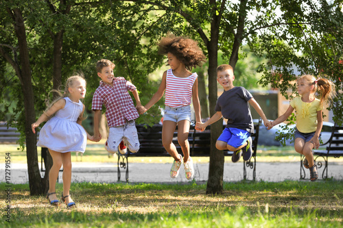 Group of children jumping in park