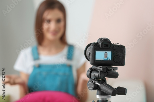 Young female blogger on camera screen