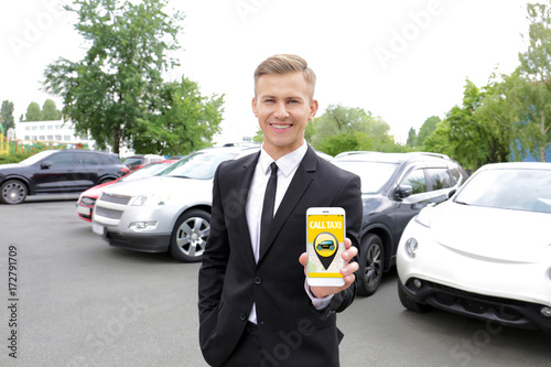 Young man calling taxi by c...