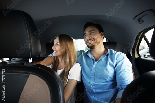 Young couple sitting in taxi car