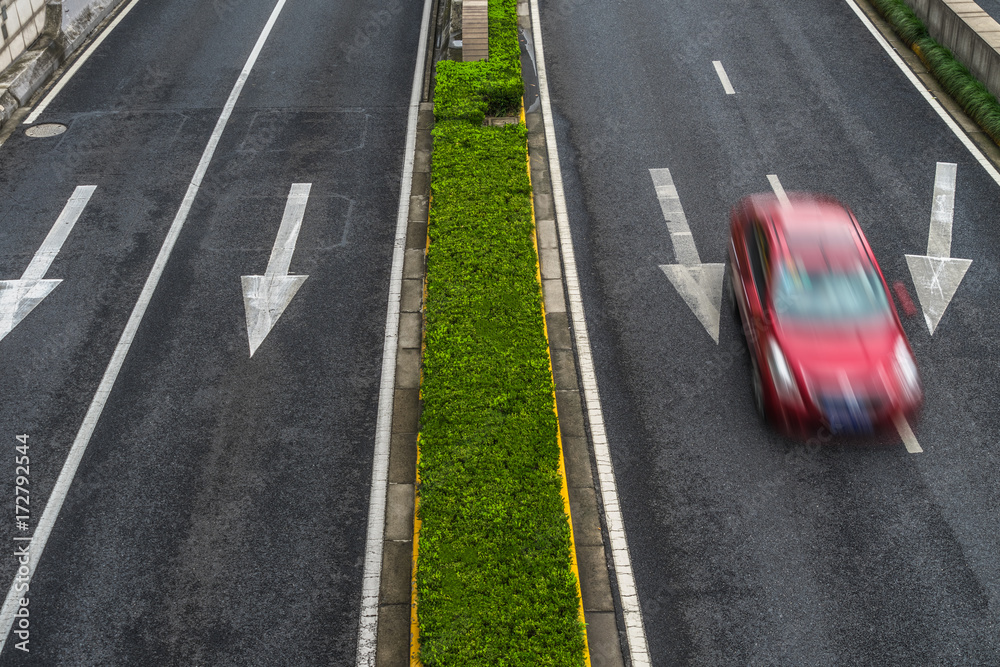 blurred car speeding on highway.